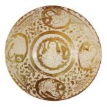 A lustre-painted pottery bowl with seated figures, Iran, 11th century, of conical form, the