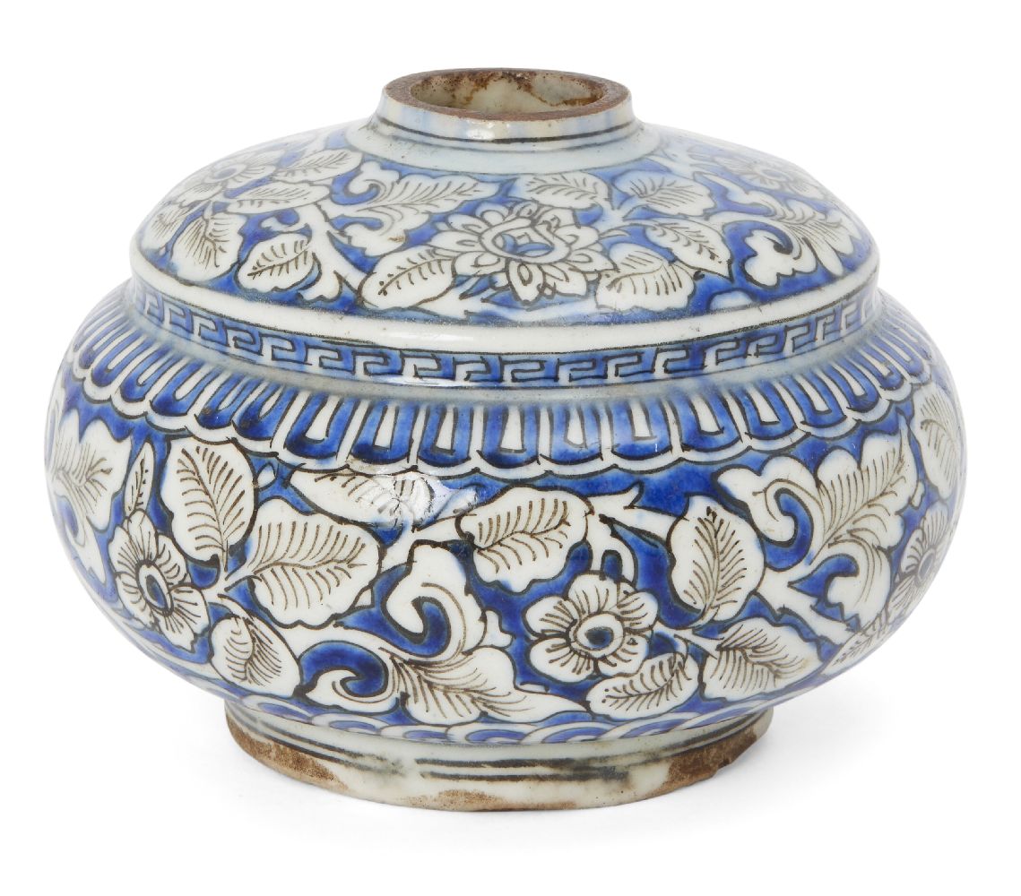 A Safavid blue and white kendi base, Iran, late 17th century, of rounded form with step to shoulder,