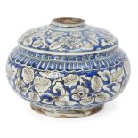 A Safavid blue and white kendi base, Iran, late 17th century, of rounded form with step to shoulder,