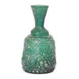 A Qarakhanid glass bottle, Central Asia, 11th-12th century, of dome-shaped form, flared neck,