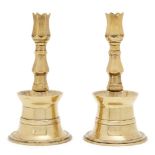 A pair of Ottoman brass tulip candlesticks, Turkey, 17th/18th century, each rising from a conical