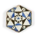 A hexagonal Damascus Iznik tile, 16th century, underglaze painted in black, white and cobalt-blue,