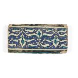 A Damascus Iznik border tile, 16th century, of rectangular form, the cobalt ground decorated in