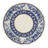 A Qajar blue and white underglaze painted dish, Iran, late 19th century, of shallow form, the