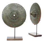 A pair of engraved bronze shield bosses, India, 13th-14th century, of rounded form with openwork