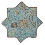 An Ilkhanid Ladjvardina moulded pottery star tile, Iran, late 13th century, moulded under the