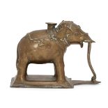 A brass votive in the form of an elephant, India, 19th century, on a rectangular base, the four feet