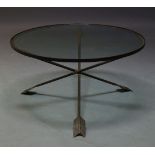 A French wrought iron and glazed coffee table, c.1960s, the circular glazed top on arrow-form