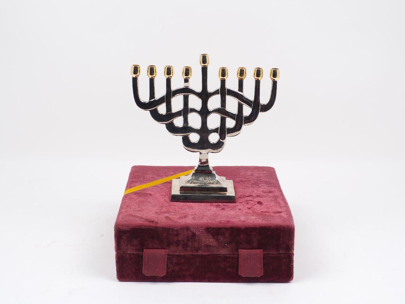 A modern Fred Hollings Jewish menorah, of typical form, with stylised overlapping branch design,