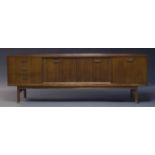 G-plan, a teak sideboard, c.1950s, with three drawers, four sliding doors, and one fall front