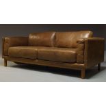 A modern leather three seater sofa, of recent manufacture, with six loose cushions, on square