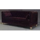 A button back sofa, of recent manufacture, with purple velvet upholstery, with single loose seat