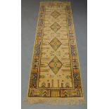 A silk runner, late 20th Century, with four diamond lozenges in an ivory field, the border with