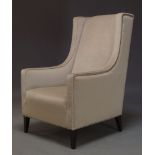 AMENDMENT: Please note VAT is charged on the hammer price for this Lot. A modern wingback armchair