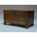 A panelled oak coffer, 17th Century, the hinged lid enclosing storage space, with arcaded frieze,