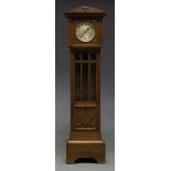 An oak grandfather clock, early 20th Century, with arched hood, the circular glazed door flanked