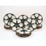 A set of fifteen Majolica oyster dishes, the circular bowls designed with six recessed shells, to