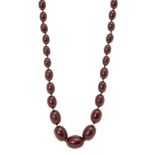 A cherry amber graduated bead necklace, late 19th century, consisting of forty-three oval beads, 1cm