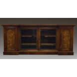 A Victorian burr walnut and gilt metal mounted credenza, the inverse breakfront top above two glazed