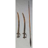 A pair of Indian talwar swords, 19th century, with curving blades, cross form guards and shaped