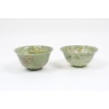 Two Chinese semi-translucent jadeite bowls, of typical form, each with flared rim, with visible