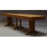 A large oak refectory table, early 20th Century, the rectangular top on triple supports, raised on
