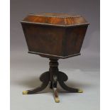 A Regency mahogany cellarette, of sarcophagus form, the hinged lid with egg and dart moulding,