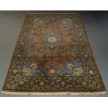 A Tabriz carpet, late 20th Century, with central blue and ivory pole medallion, in pale brown field,