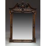 A mahogany framed mirror, 20th Century, with swan neck pediment, centred by vacant cartouche, the