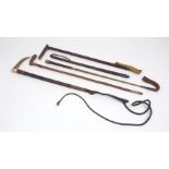A group of early 20th century riding crops and whips, to include a antler handled whip example, with