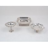 Three pierced silver dishes, comprising a squared bonbon dish raised on four scroll feet, Sheffield,