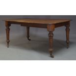 A Victorian mahogany extending dining table, the rounded rectangular top with one additional leaf,