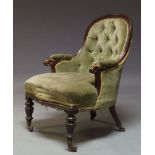 An Regency mahogany and button back armchair, upholstered in green velvet fabric, the spoon shaped