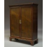 A mahogany cupboard in the Georgian taste, early 20th Century, the moulded top above two paneled