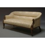 A late Victorian sofa, upholstered in yellow floral pattern fabric on front mahogany and ebonised