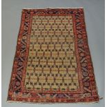 A Northwest Persian rug with oatmeal coloured field and indigo main border, 186cm x 127cmminor