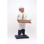 A late 19th / early 20th century wind-up automaton, portrayed as a chef handling a tray with