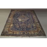 A West Persian carpet, mid 20th Century, with ivory medallion in deep blue field, decorate with