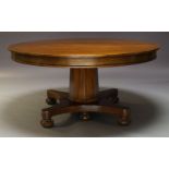 A Victorian mahogany extending dining table, the circular top with six additional leaves, raised