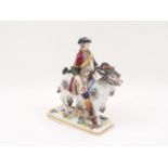 A Capodimonte porcelain figure, 19th century, designed a gentleman riding a goat, to a florally