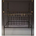 A Victorian black painted four poster double bed, with brass finials and fittings, the posts with