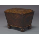 A Regency flame mahogany cellarette, of sarcophagus form, the hinged lid enclosing metal liner,