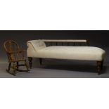 A Victorian chaise longue, upholstered in cream fabric, the back rail with turned baluster supports,