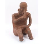 A Pre-Colombian Nayarit terracotta figure, (probably 100BC - AD), modelled as a seated man,