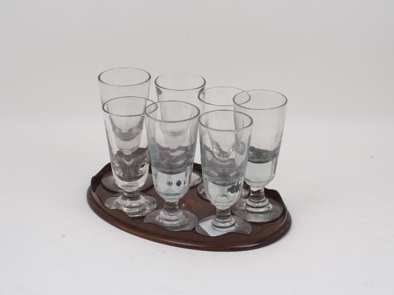 A group of drinking glasses, 19th century of inverted conical form, each upon spreading foot,