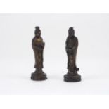 A pair of Guanyin figures, 20th century, each metal body modelled standing, dressed in drapery, to