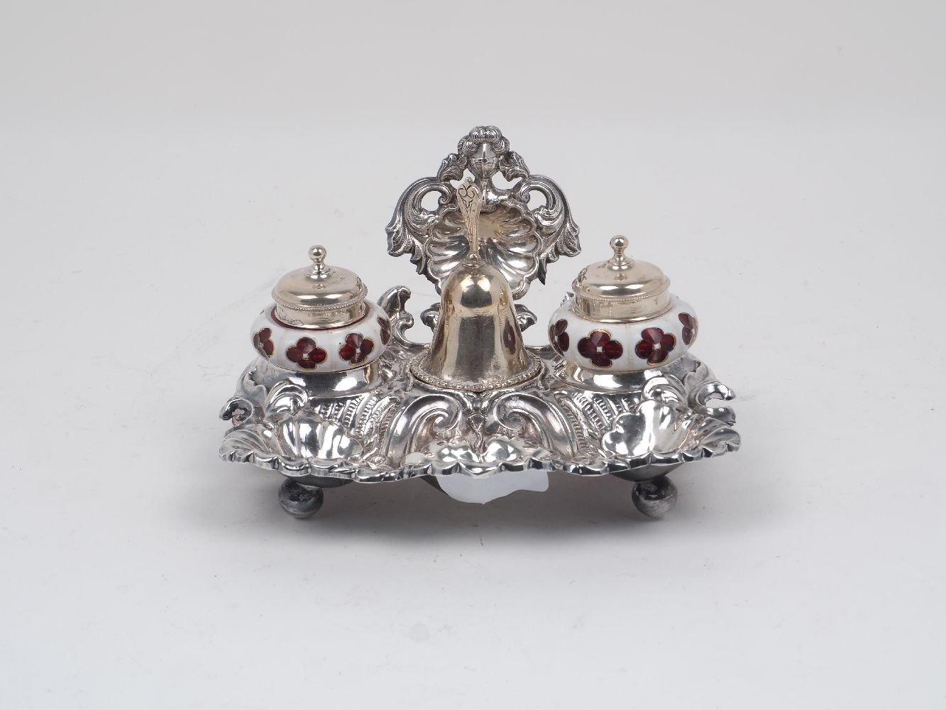 A late 19th/early 20th century continental white metal inkwell stand with a bell and two removable