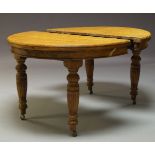 An oak extending wind out dining table, early 20th Century, with two d-ends and two additional
