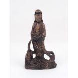 A 20th Century soapstone figure of Guanyin pouring water into a dragon's mouth, 29cm highPlease