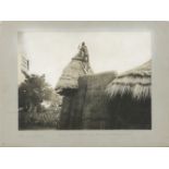 Early 20th Century, German School, a native African man climbing on a roof, photograph on board,